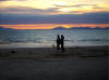 a beautiful sunset along a near-deserted beach