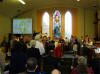 taken during the service as members of the congregation were asked to take flowers to cover the cross; the young peoples' band played as the songsters led us in worship